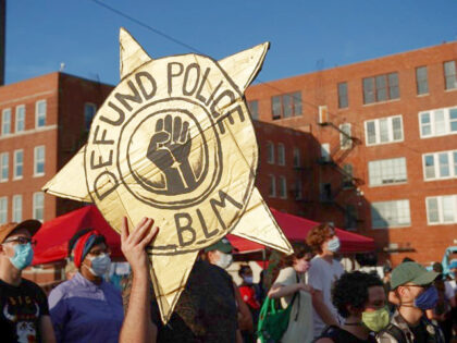 Black-led groups lead a rally to defund police across from the Chicago Police Department&a
