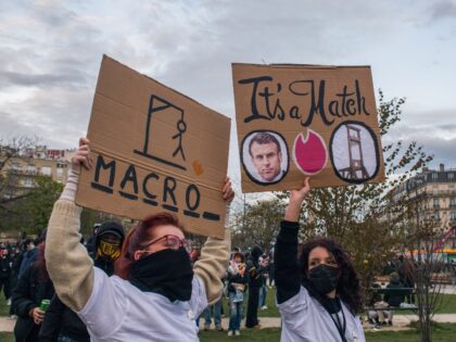 Protestors hold placards featuring images of French President Emmanuel Macron and guillotines during a demonstration against pension reform at Place de la Nation in central Paris, France, on Tuesday, March 28, 2023. French unions are holding a new day of nationwide strikes Tuesday to try to force President Emmanuel Macron …