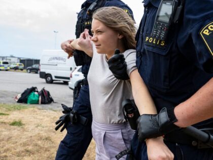 Police officers carry Swedish climate activist Greta Thunberg away together with other climate activists from the organization 'Ta Tillbaka Framtiden' (Take Back the Future), who block the entrance to Oljehamnen neighbourhood in Malmo, Sweden, on June 19, 2023, for the 5th day in a row. (Photo by Johan NILSSON / …