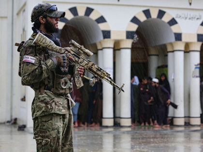 A Taliban security personnel stands guard as Muslim devotees arrive to take part in Eid al-Adha prayers at a mosque in Jalalabab on June 28, 2023. (Photo by Shafiullah KAKAR / AFP) (Photo by SHAFIULLAH KAKAR/AFP via Getty Images)