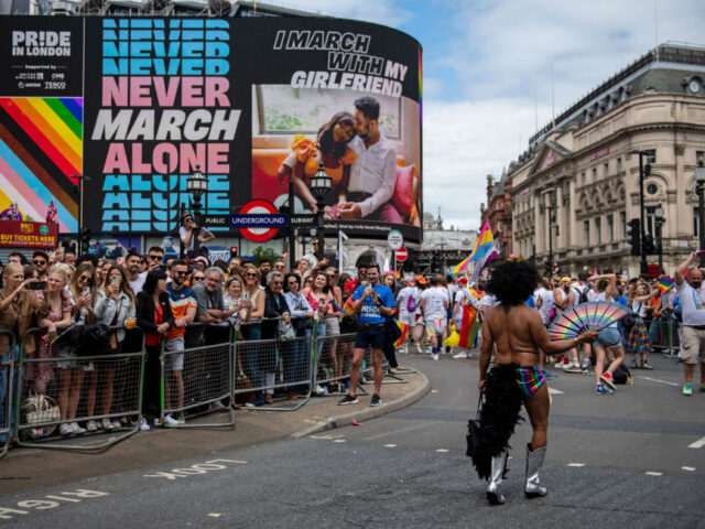 Participants march through Piccadilly Circus during The Pride in London Parade in London,