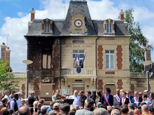Local residents and representatives gather in front of the city hall during a nationwide action in Persan, on the outskirts of Paris, on July 3, 2023, after France's mayors have called on the population and elected representatives to gather in front of all town halls at midday, invoking "civic mobilisation" …