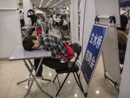 BEIJING, CHINA - JUNE 9: A woman rests on a table at a job fair on June 9, 2023 in Beijing
