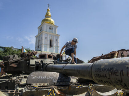 KYIV, UKRAINE - JULY 05: A boy chief rides a tank in front of St. Michael's Monastery as daily life continues amid the Russia-Ukraine war in Kyiv, Ukraine on July 05, 2023. As stores and restaurants continue their business in the capital city of Kyiv, citizens stroll through parks with …