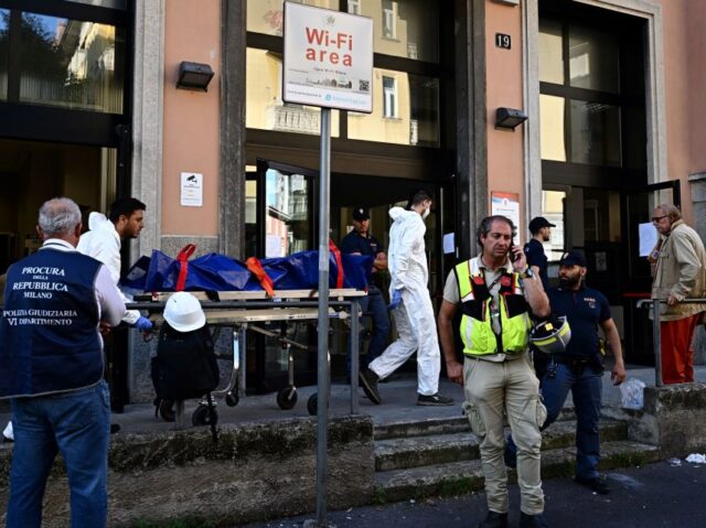 ITALY-FIRE Members of the police evacuate the body of a victim after a fire killed six people at a re