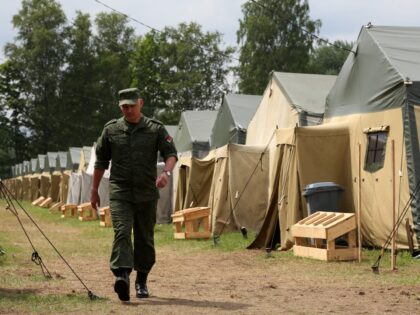 ASIPOVICHY, BELARUS - JULY 07: A Belarusian soldier walks through a newly-built camp on a