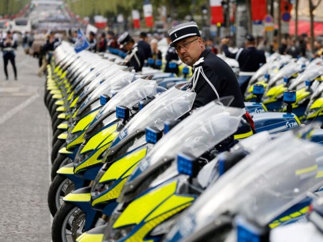 A French gendarme stands among motorcycles during the Bastille Day military parade on the
