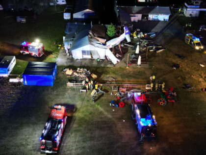 TOPSHOT - This aerial view shows emergency vehicles near the site where a small plane cras