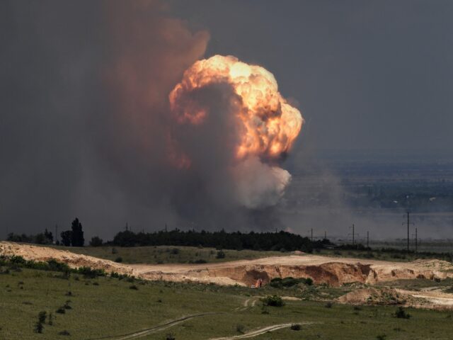 TOPSHOT - A picture shows detonation of ammunition caused by a fire at a military training