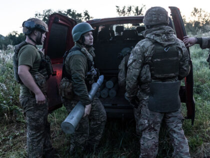 DONETSK OBLAST, UKRAINE - JULY 22: A Ukrainian soldier carries shells to their front line