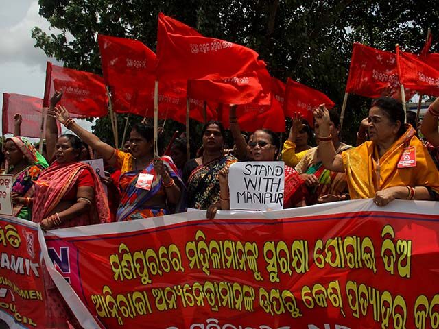 Local women activists hold placards and shouted anti government slogans as they assembled