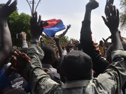 Protesters cheer Nigerien troops as they gather in front of the French Embassy in Niamey d
