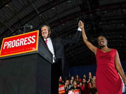 Newly elected New York City Mayor Bill de Blasio (L) holds hands with his wife Chirlane Mc