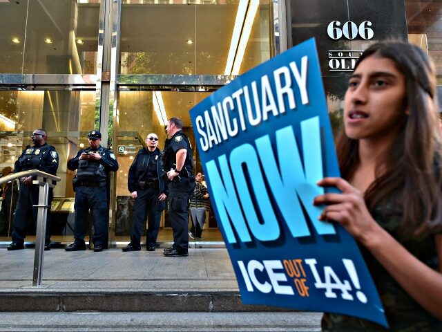 Department of Homeland Security police officers stand guard in front of the Los Angeles Immigration Court building where protesters gathered following a rally by supporters of US born daughters of undocumented Romulo Avelia-Gonzalez, who was arrested by ICE agents last week, in downtown Los Angeles, California on March 6, 2017. …