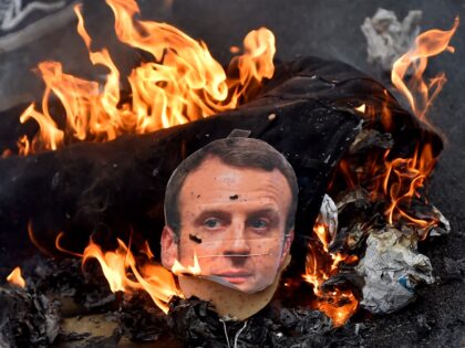 This photo taken on April 7, 2018 shows a burning effigy of French president Emmanuel Macron during a demonstration calling for a union between French rail agent and student protest movements in Nantes, western France. (Photo by LOIC VENANCE / AFP) (Photo by LOIC VENANCE/AFP via Getty Images)