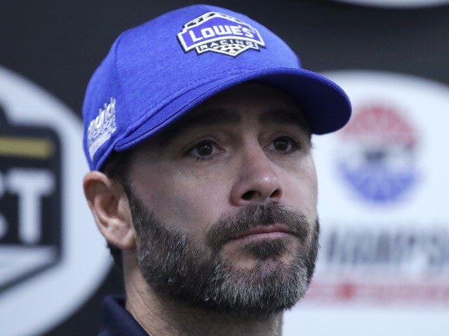 Driver Jimmie Johnson listens to a reporter's question prior to qualifying for the NA