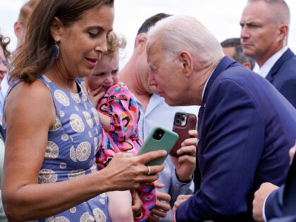 President Joe Biden talks to a child as he greets embassy staff members and their families before boarding Air Force One at Helsinki-Vantaan International Airport in Helsinki, Finland, Thursday, July 13, 2023. Biden is returning to Washington after meeting with Nordic leaders in Helsinki and attending the NATO Summit in …