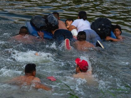 MATAMOROS, MEXICO - May 11: Migrants traverse the Rio Grande River in order to cross the U
