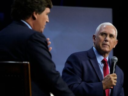 Republican presidential candidate former Vice President Mike Pence talks with moderator Tucker Carlson, left, during the Family Leadership Summit, Friday, July 14, 2023, in Des Moines, Iowa. (AP Photo/Charlie Neibergall)
