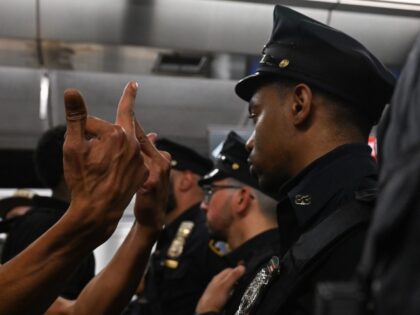 NEW YORK, NEW YORK - MAY 06: (EDITORS NOTE: Images contains profanity.) A protester gestures to NYPD officers at the Lexington Ave/63rd Street subway station during a "Justice for Jordan Neely" protest that began outside the Broadway-Lafayette station on May 06, 2023 in New York City. More than 15 people …