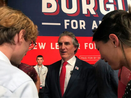 North Dakota Gov. Doug Burgum talks with supporters after he announced his bid for the Rep
