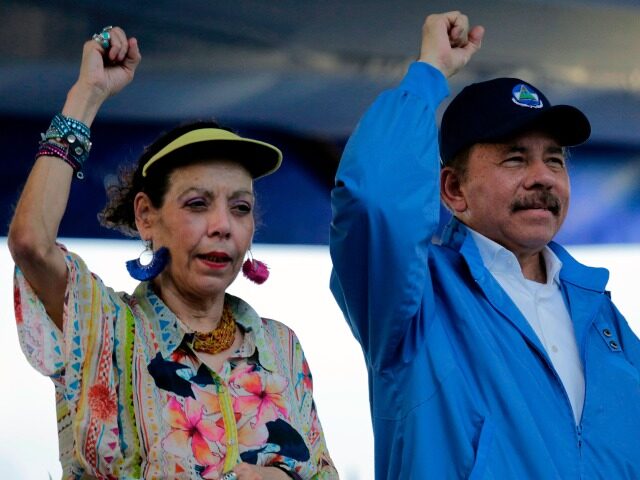 Nicaraguan President Daniel Ortega and his wife, Vice-President Rosario Murillo, raise the