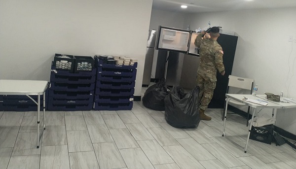 A national guard soldier restocks food for migrants staying in a New York City hotel. (Photo: Danny -- Venezuelan Migrant)