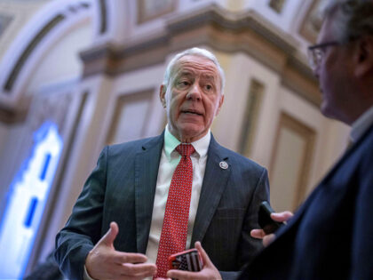 Rep. Ken Buck, R-Colo., a member of the conservative House Freedom Caucus, stops for a rep