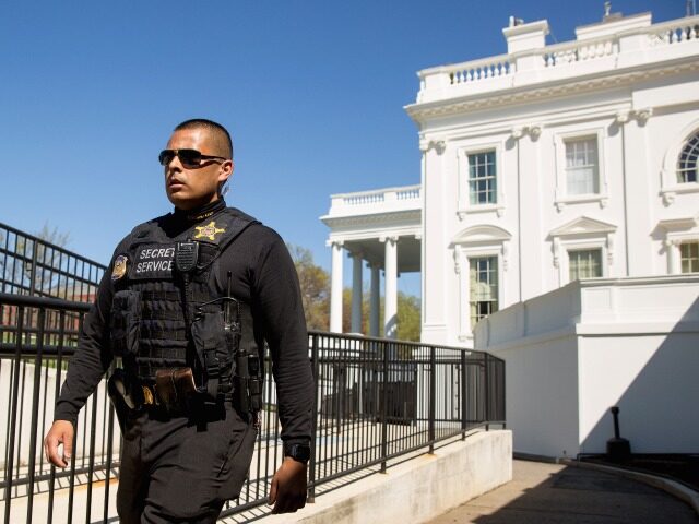 A member of the uniformed Secret Service walks near the press briefing room and the North