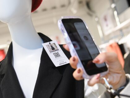A customer scans a QR code for online purchasing at the Shein Tokyo showroom in Tokyo, Jap