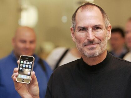 Steve Jobs holding iPhone 1