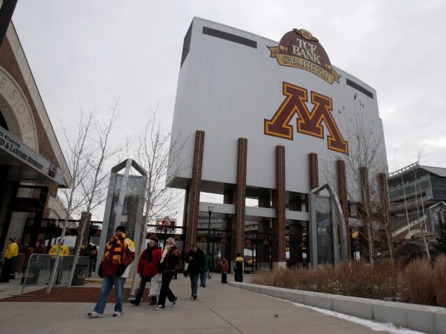 FILE - In this Nov. 24, 2012 file photo, Minnesota fans walk outside TCF Bank Stadium befo