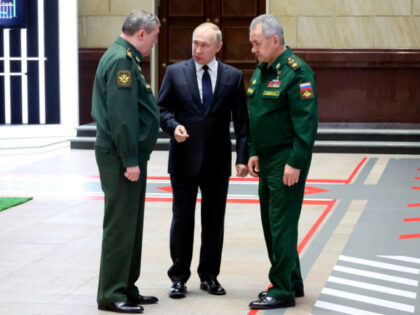 FILE - Russian President Vladimir Putin, center, speaks with Chief of the General Staff Ge