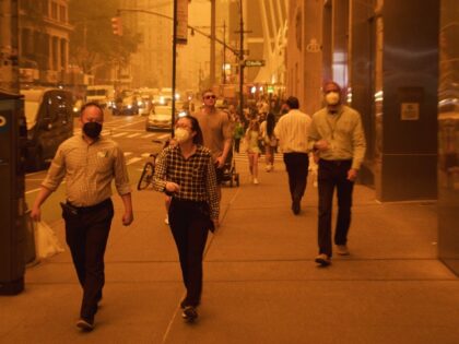 Pedestrians wearing face masks walk on a street in New York, the United States, June 7, 2023. Smoke from raging wildfires in Canada has triggered air quality alerts in a number of U.S. states, with the sky over New York City rapidly darkening Wednesday afternoon and New York State Governor …