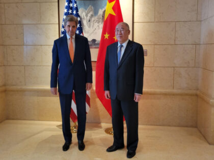 John Kerry, US special presidential envoy for climate, left, greets Xie Zhenhua, China's s
