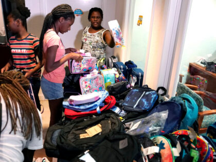 Chrishauna Hurst, 12, center, and Aaliyah Floyd, 10, right, select lunch boxes at the annual Back to School Distribution Day at The Pantry, Friday, July 29, 2022, in Fort Lauderdale, Fla. The Pantry works with grandparents who are the primary caregivers for their grandchildren, offering free backpacks, lunch boxes, school …
