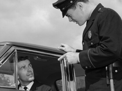 1960s POLICE OFFICER WARNING MOTORIST POINTING FINGER AT DRIVER (Photo by H. Armstrong Rob