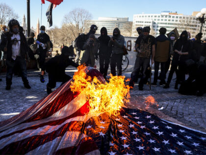 Members of the Communist Party USA and other anti-fascist groups burn an American flag on the steps of the Colorado State Capitol on January 20, 2021 in Denver, Colorado. Joe Biden was sworn in as the 46th President of the United States with Vice President Kamala Harris at an inauguration …