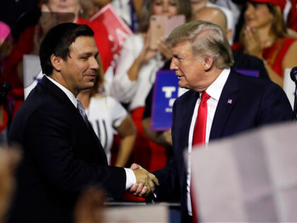 FILE - In this July 31, 2018, file photo, President Donald Trump, right, shakes hands with Florida Republican gubernatorial candidate Ron DeSantis during a rally in Tampa, Fla. Florida voters are going to the polls, Tuesday, Aug. 28, 2018, to select nominees to replace Republican Gov. Rick Scott in an …