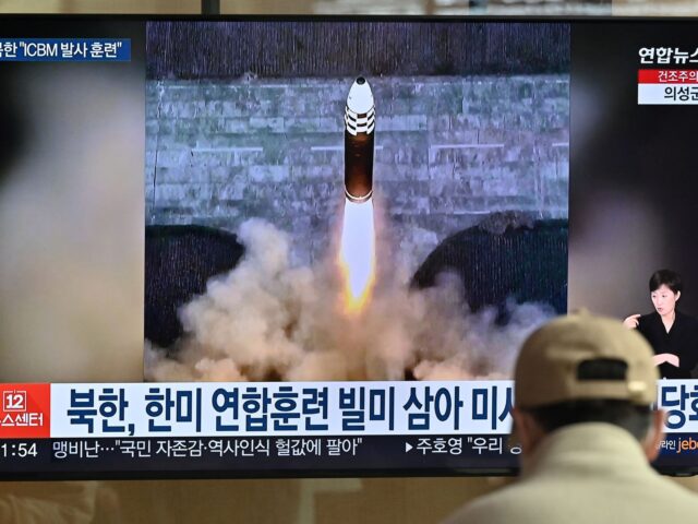 A man watches a television news screen showing a picture of North Korea's recent test-firi
