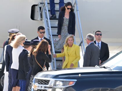 US First Lady Jill Biden (3rdR) is welcomed as she arrives to celebrate the US rejoining U