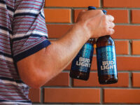 UKRAINE - 2021/08/28: In this photo illustration, a man holds Bud Light beer bottles. (Photo Illustration by Igor Golovniov/SOPA Images/LightRocket via Getty Images)