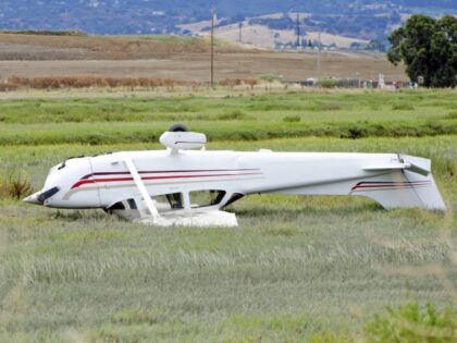 Private airplane accident Cessna 172 - stock photo Private airplane accident. Airplane flipped in field short of runway. (All passengers walked away.) Cessna 172.