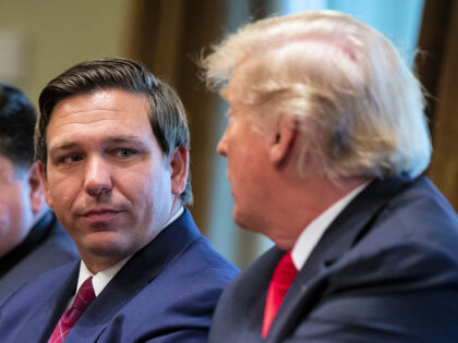 Ron DeSantis, governor-elect of Florida, listens as U.S. President Donald Trump speaks during a meeting in the Cabinet Room of the White House in Washington, D.C., U.S., on Thursday, Dec. 13, 2018. Trump reaffirmed his promise to punish General Motors Co. for plans to close an auto factory in the …