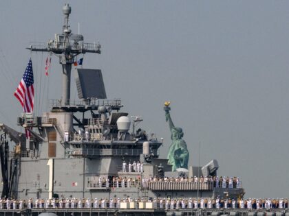 US Sailors and Marines stand on the flight deck of the USS Bataan, a Wasp-class amphibious assault ship, as it passes the Statue of Liberty during Fleet Week in New York Harbor on May 24, 2023. (Photo by ANGELA WEISS / AFP) (Photo by ANGELA WEISS/AFP via Getty Images)