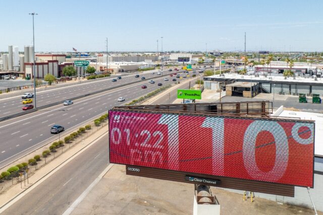 In an aerial view, a billboard displays the temperature that was forecast to reach 115 deg