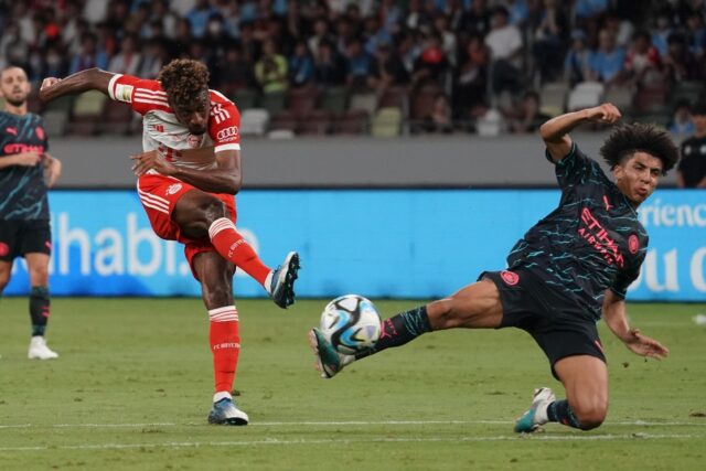 Bayern Munich forward Kingsley Coman (L) shoots as Manchester City attempts to block