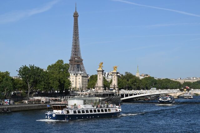 Boats parade past the Eiffel Tower in a rehearsal of the Paris Olympics opening ceremony o