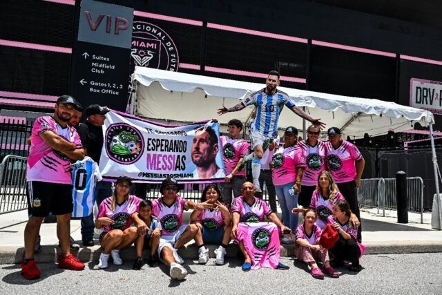 Fans of Argentina's Lionel Messi wait for his arrival at the DRV PNK Stadium in Fort Laude