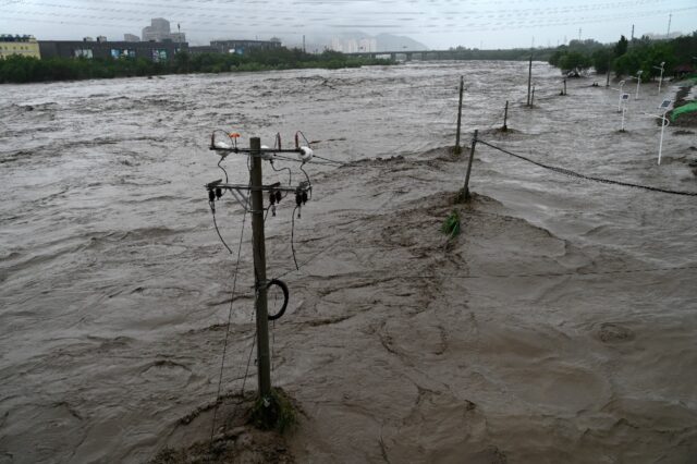 Heavy rains battered northern China on Monday, killing at least two people in Beijing